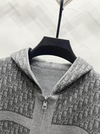Grey hooded zip jacket close-up of zipper and hood lining with repeating logo pattern