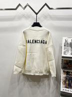 Cream knit V-neck cardigan with BALENCIAGA logo on back, long sleeves