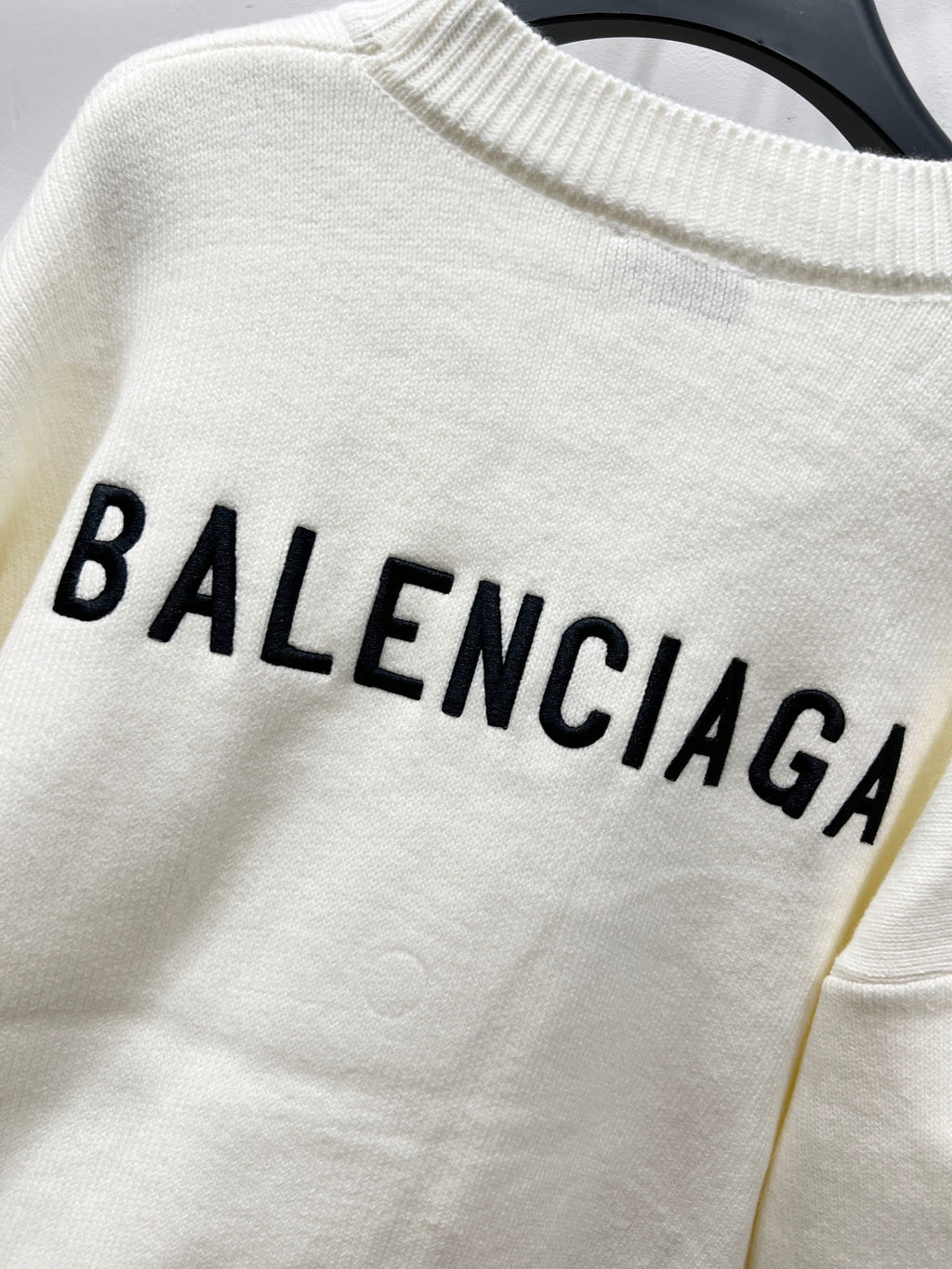 Cream knit sweater with bold BALENCIAGA lettering on chest