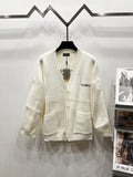 Cream knit V-neck cardigan with front buttons and BALENCIAGA logo patch