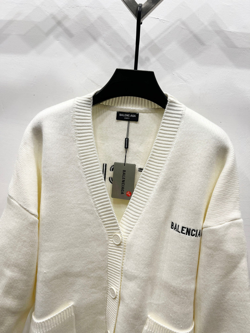 Cream knit V-neck cardigan with ribbed trim and small BALENCIAGA label