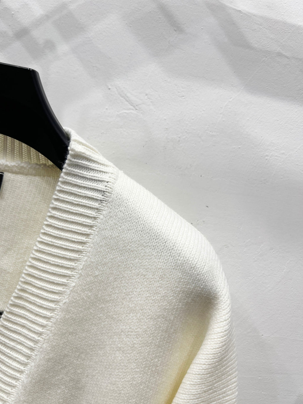 Cream knit cardigan shoulder with ribbed collar trim