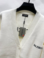 Cream knit V-neck cardigan on hanger with BALENCIAGA sleeve logo