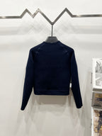 Navy long-sleeve jacket with high collar and ribbed hem, back view