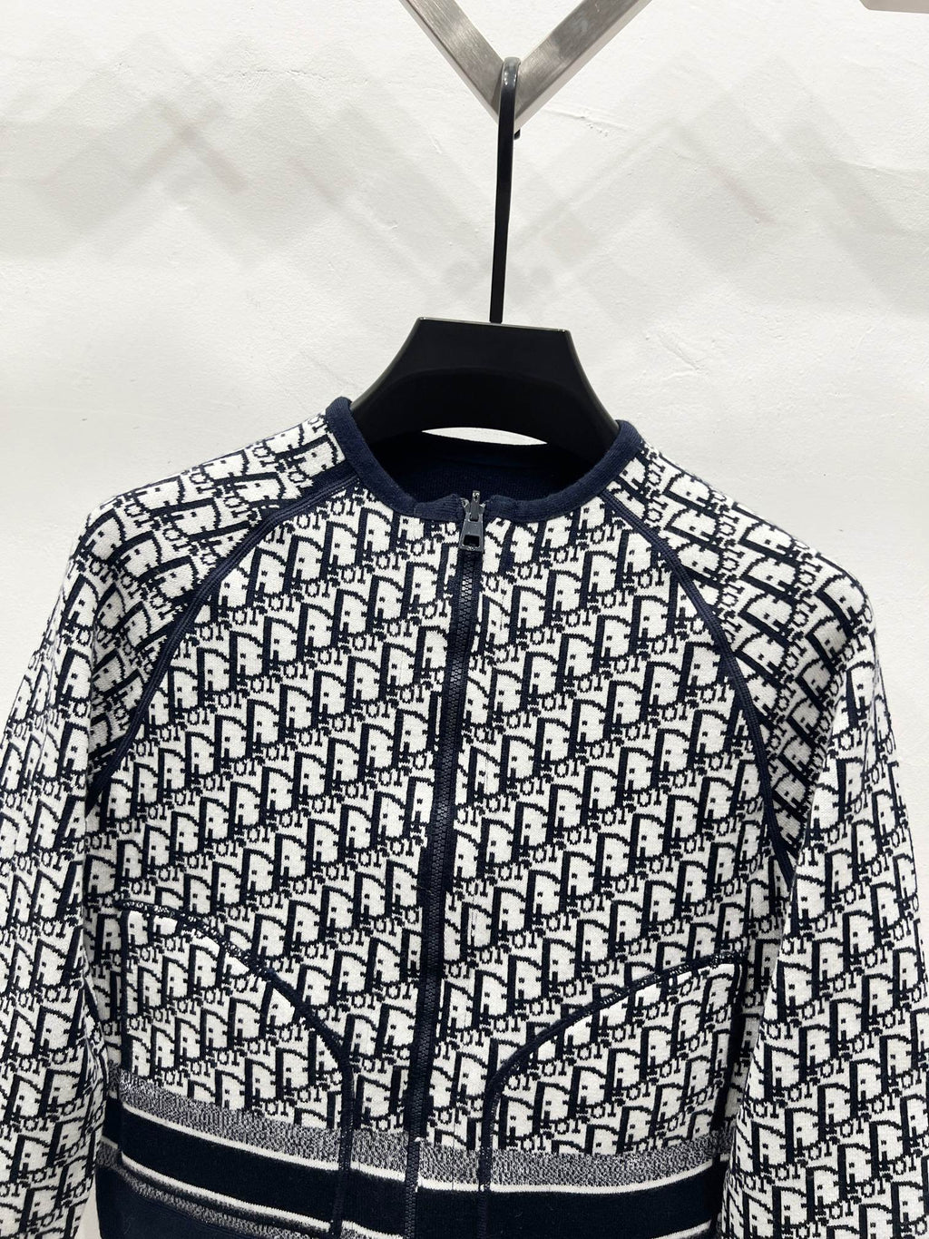 Dior-logo patterned zip jacket close-up with knit stand collar and banded hem