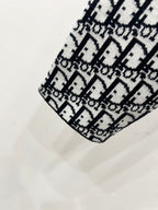 Black-and-white Dior monogram knit shoulder detail on patterned jacket