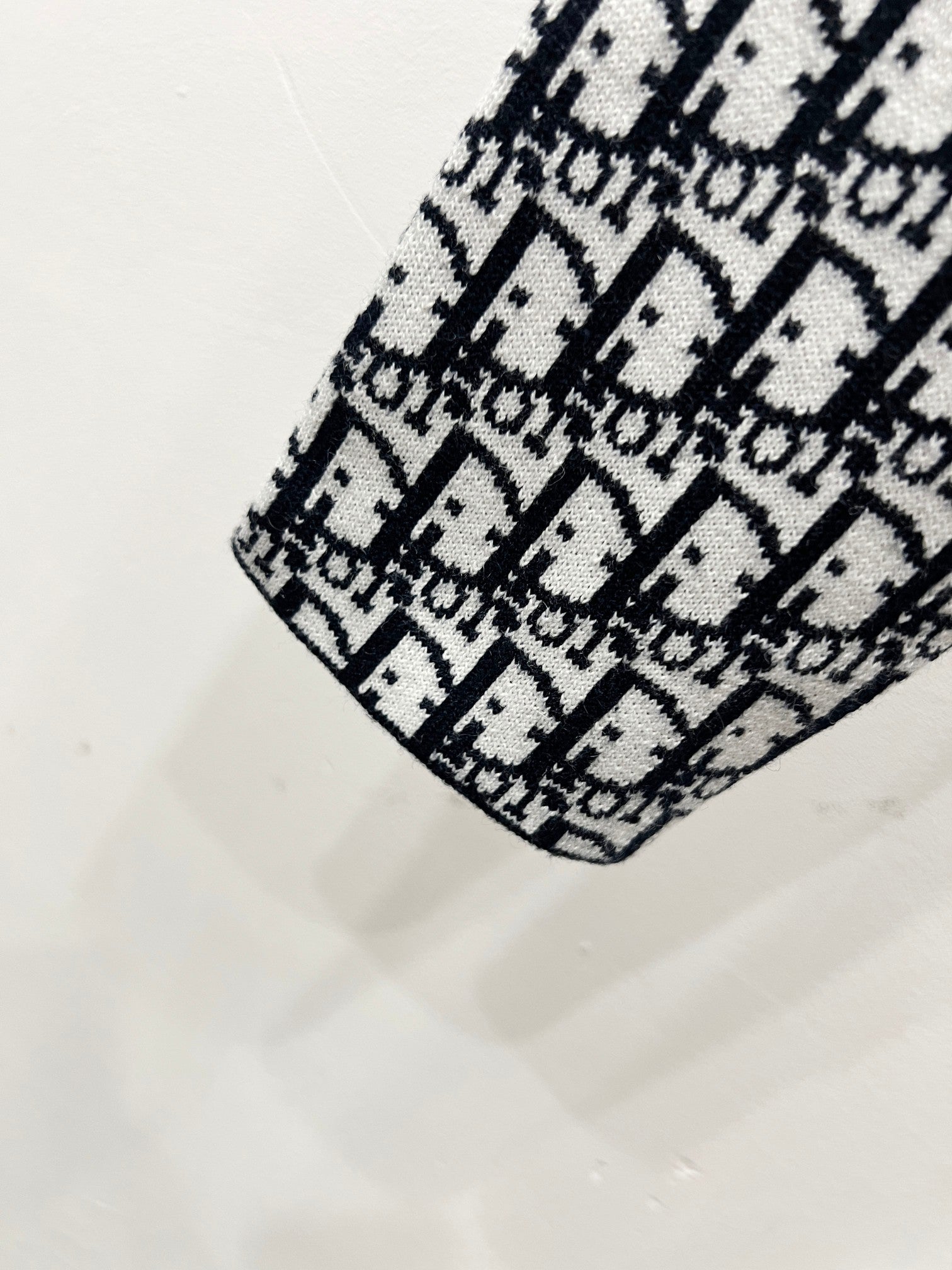Black-and-white Dior monogram knit shoulder detail on patterned jacket