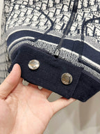 Navy ribbed sleeve cuff detail with two snap buttons