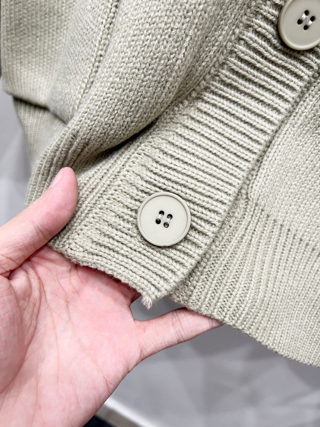 Beige knit cardigan cuff with two-button detail