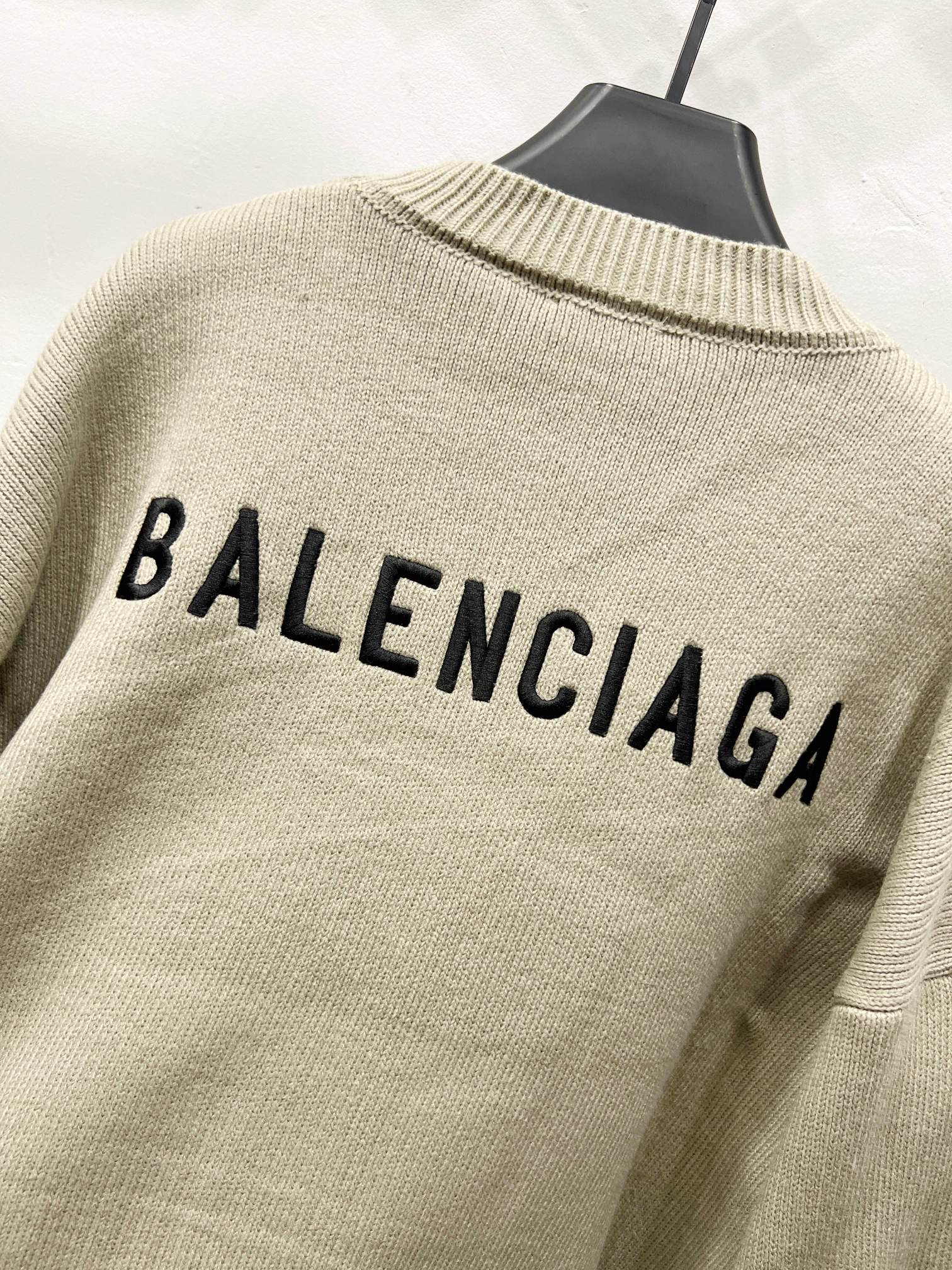 Beige knit cardigan back with BALENCIAGA text and ribbed trim