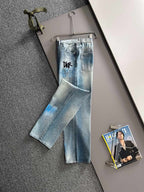 Light blue denim jeans with black logo on front leg, wide cropped fit, belt loops
