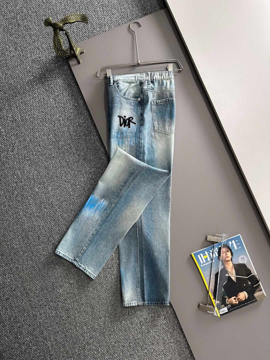 Light blue denim jeans with black logo on front leg, wide cropped fit, belt loops