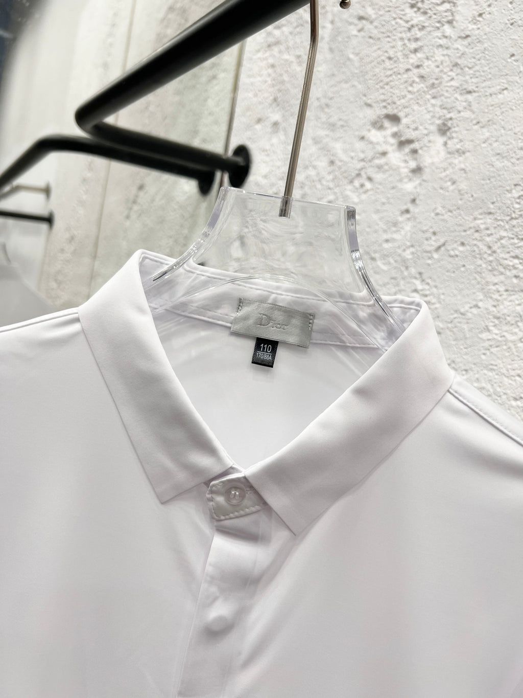 White collared button-up shirt with Dior label at neckline