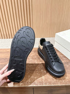 Black sneaker outsole tread shown beside low-top lace-up shoe