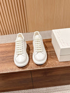 Alexander McQueen leather sneakers pair, white, lace-up with perforated toe details