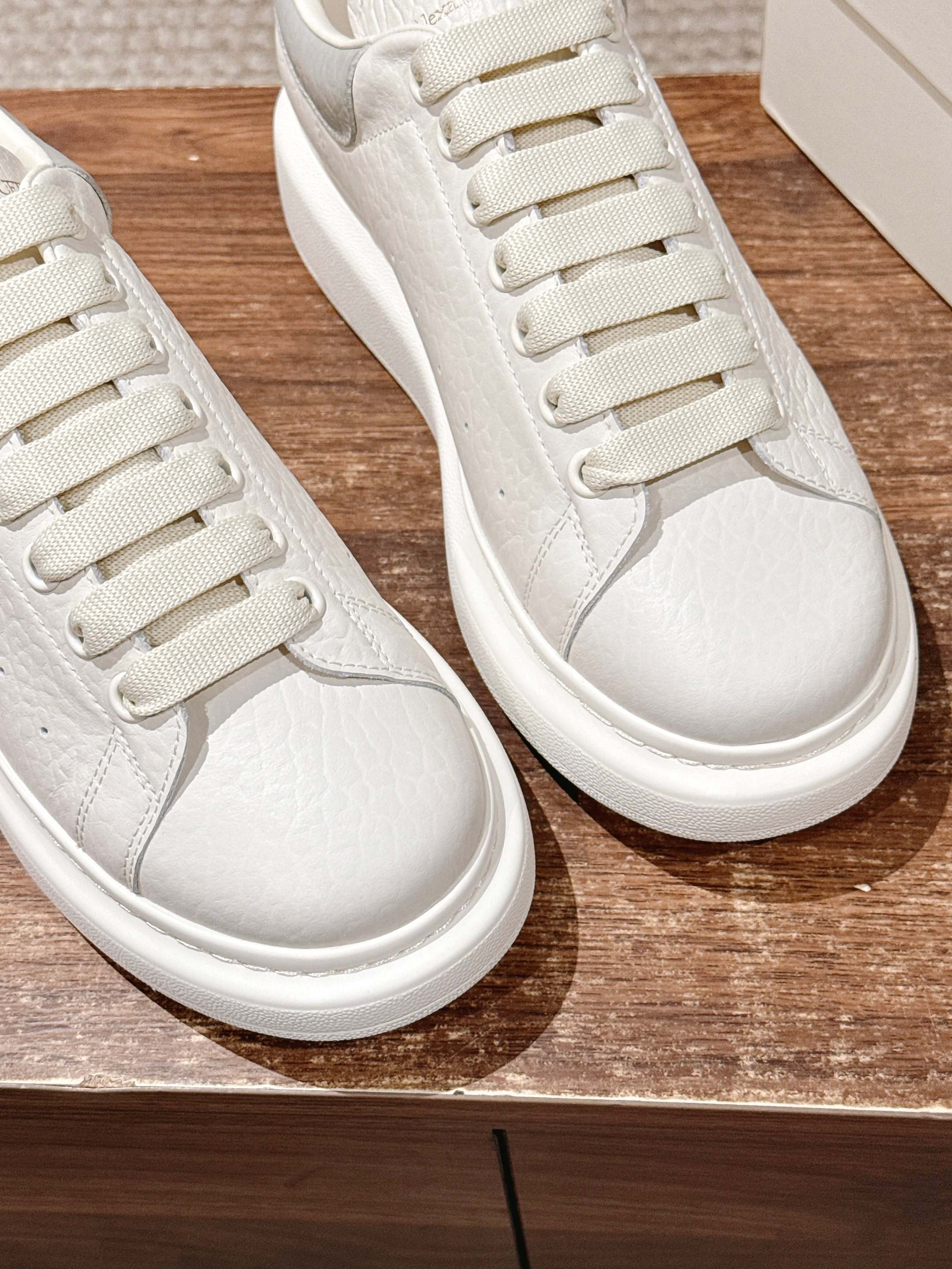 Alexander McQueen leather sneakers, white, close-up of laces and textured leather panels