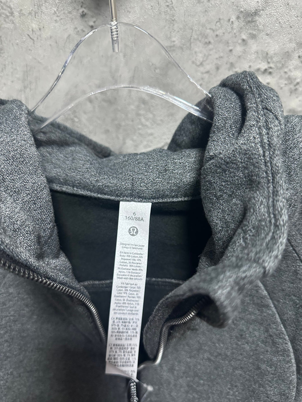 Dark gray heather hoodie back view with center hood and inner brand tag