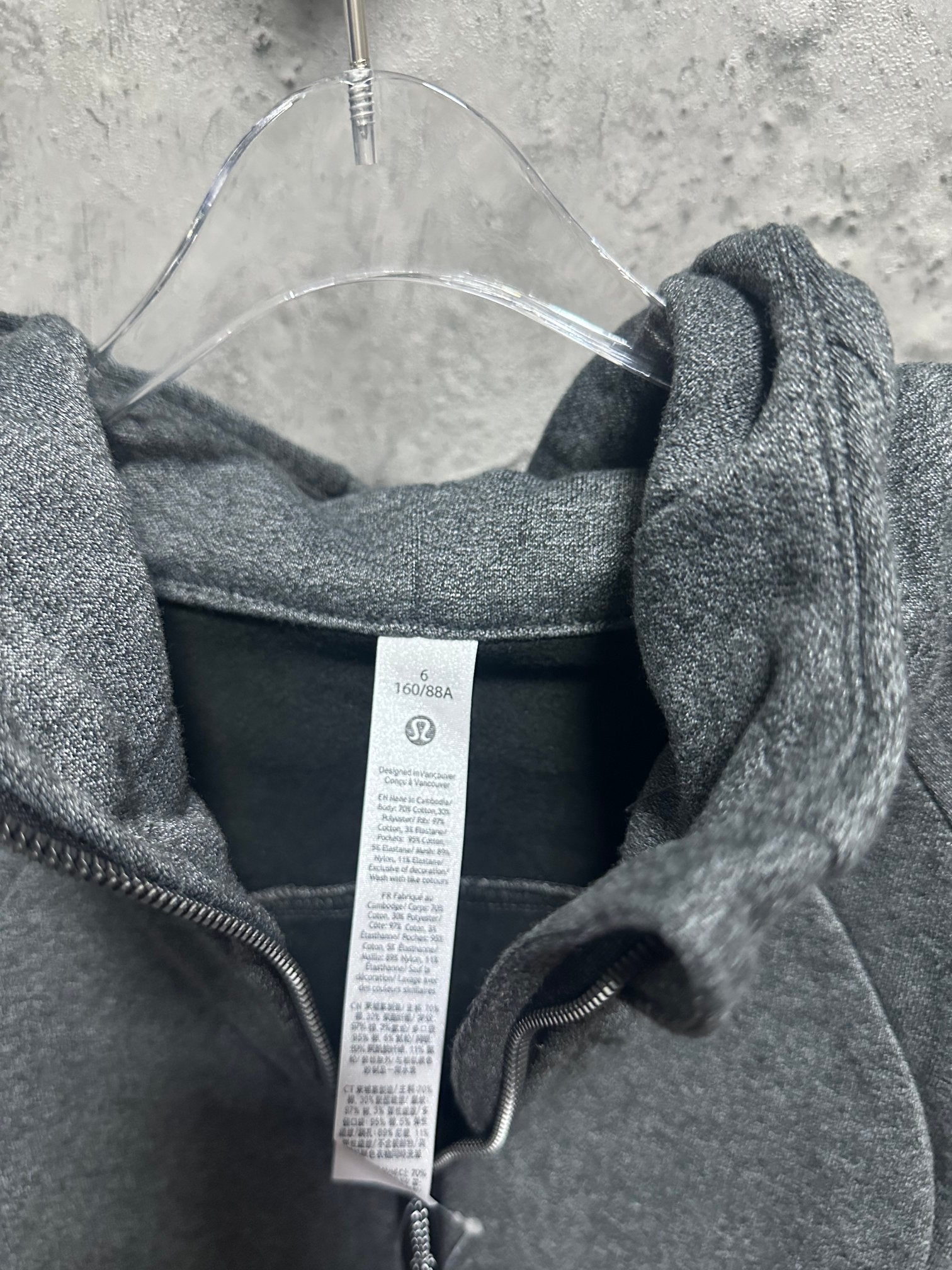 Dark gray heather hoodie back view with center hood and inner brand tag