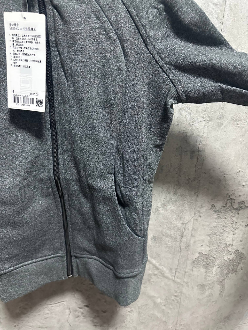 Dark gray zip-up hoodie front view with full zipper and side pocket opening