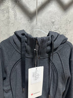 Dark gray hooded zip-up jacket with drawstrings and front zipper, lululemon tag
