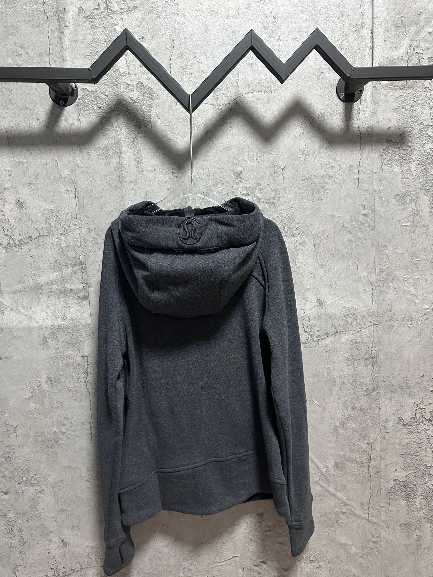 Dark gray zip-back hoodie with hood, drawstring, and small lululemon logo