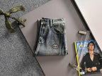 Denim pants on hanger with Gucci logo patch on pocket, button-fly, belt loops
