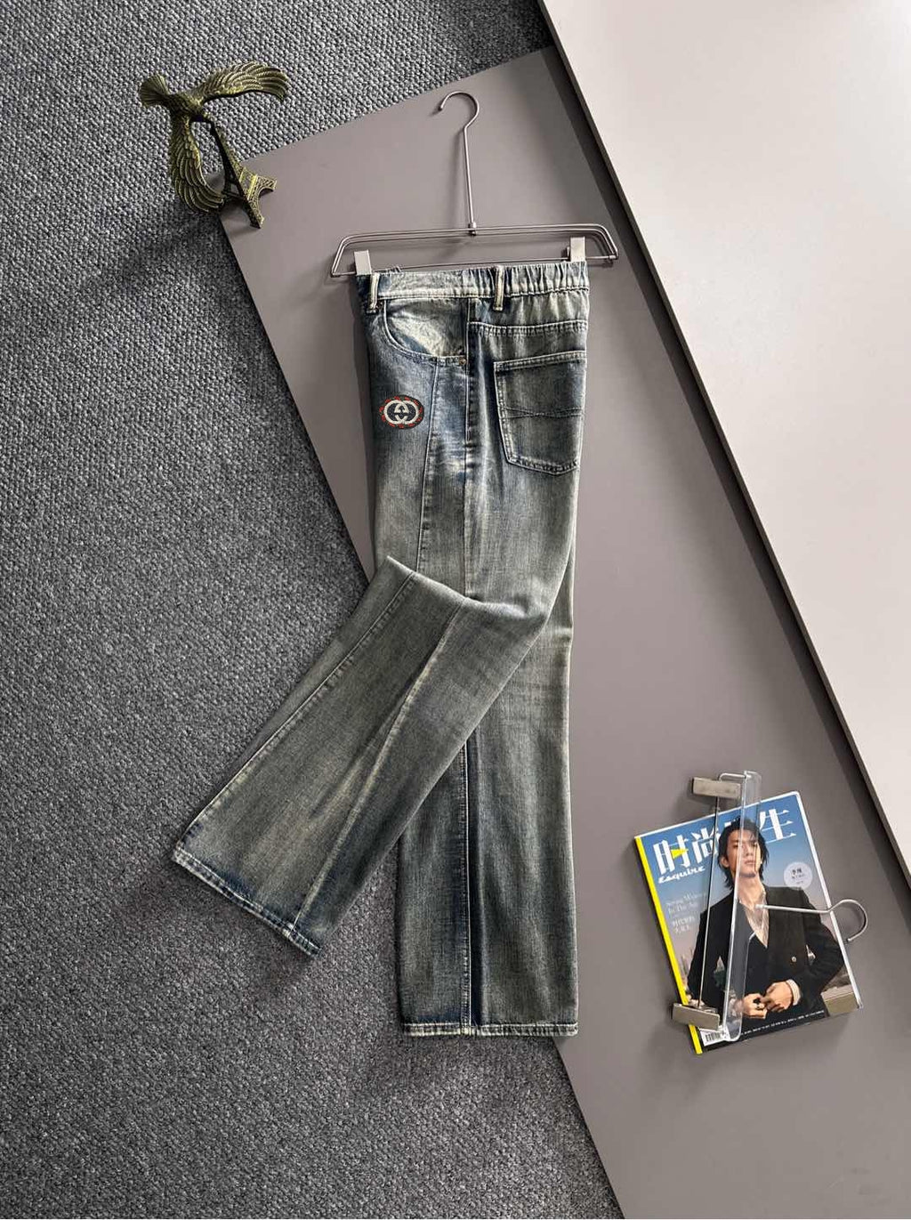 Denim pants with Gucci logo patch, front view, belt loops, button-fly