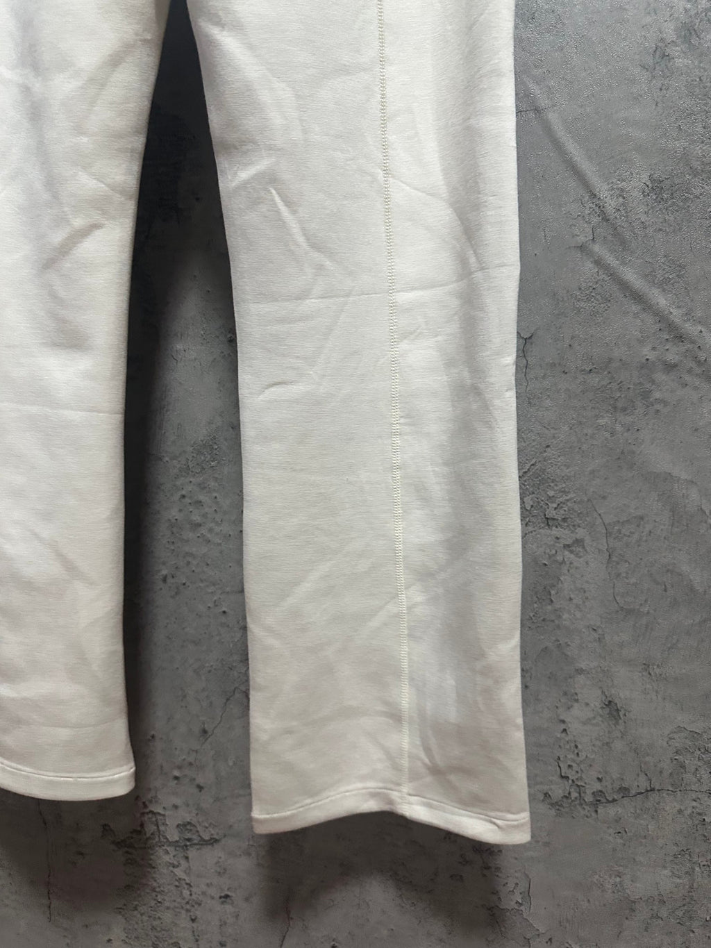 Ralph Lauren white sweatpants leg with smooth fabric and draped side seam