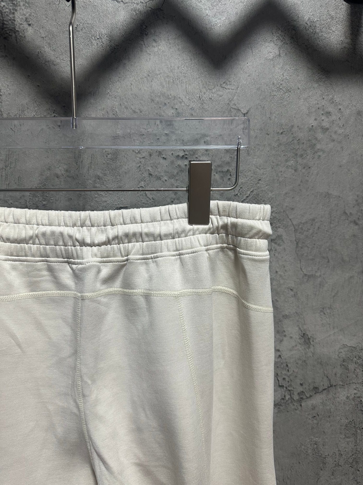 Cream sweatpants waistband with elastic ruching and straight leg cut