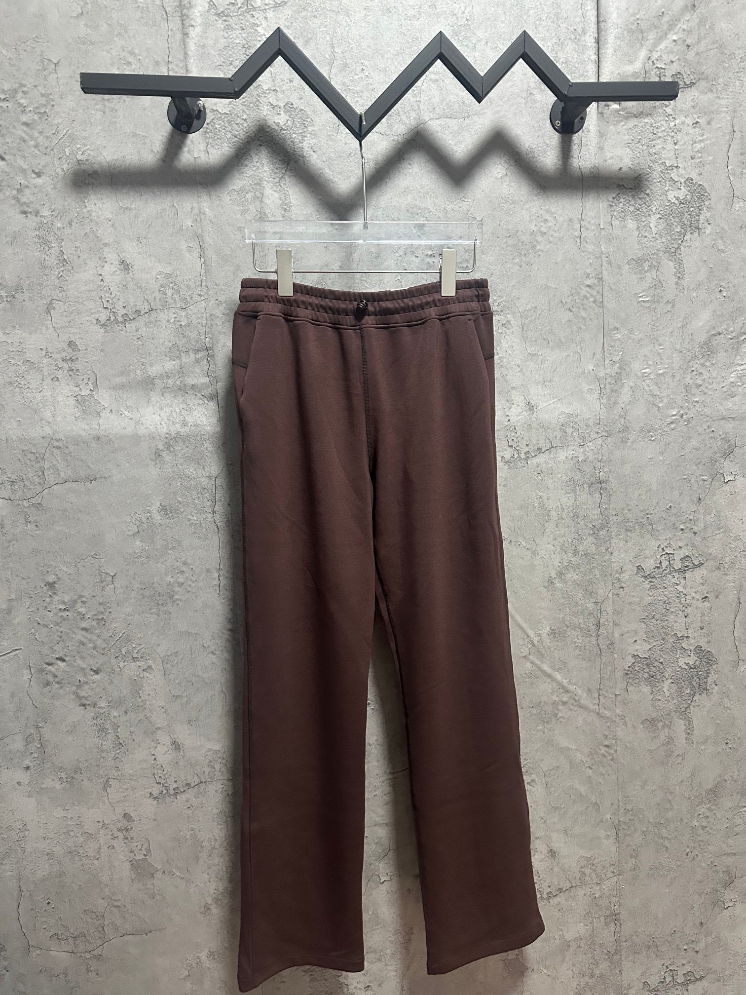Maroon drawstring sweatpants with elastic waistband and relaxed straight legs
