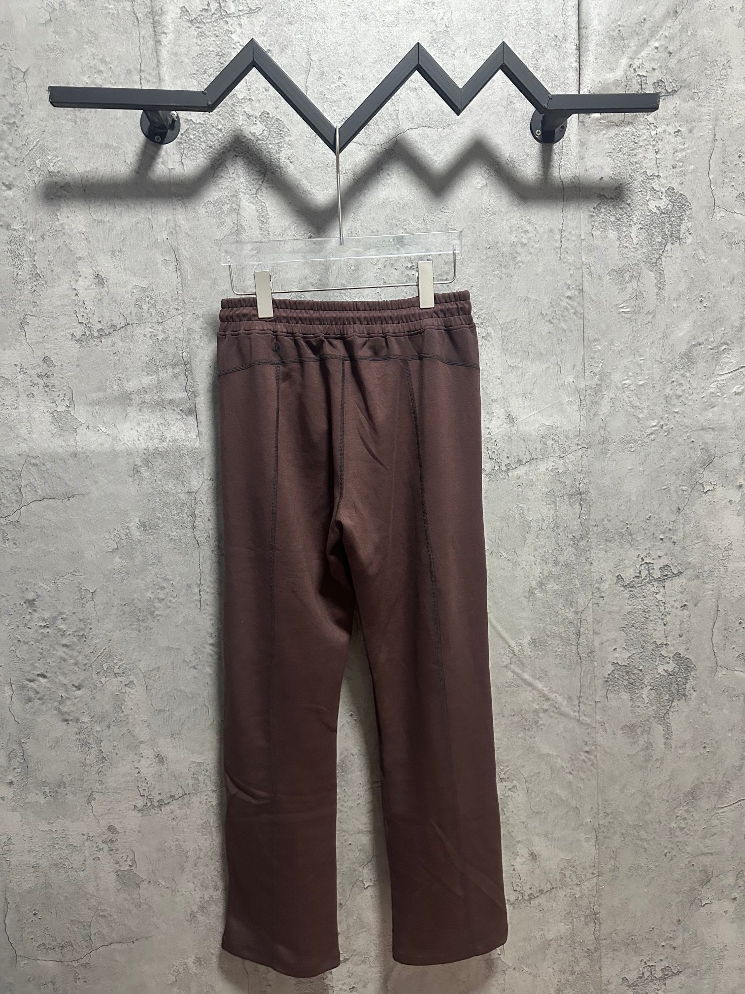 Dark brown pull-on pants with elastic waistband and relaxed straight legs