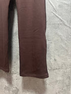Maroon sweatpants side close-up with straight leg and smooth fabric