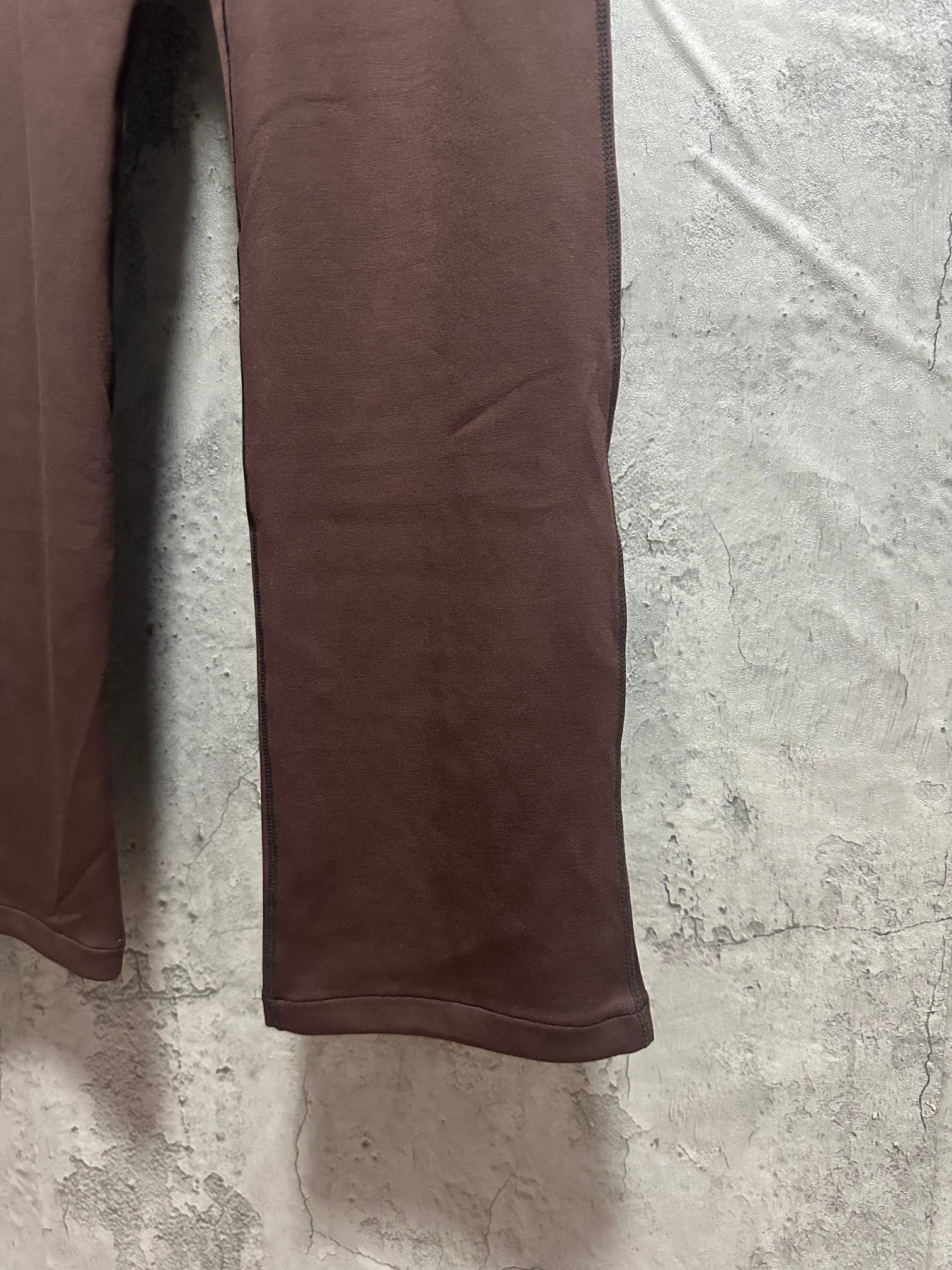 Maroon sweatpants side close-up with straight leg and smooth fabric