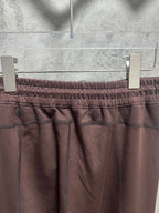 Maroon sweatpants with front pockets and elastic waistband stitching