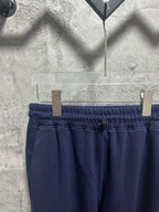 Navy trousers with elastic waistband and front button detail