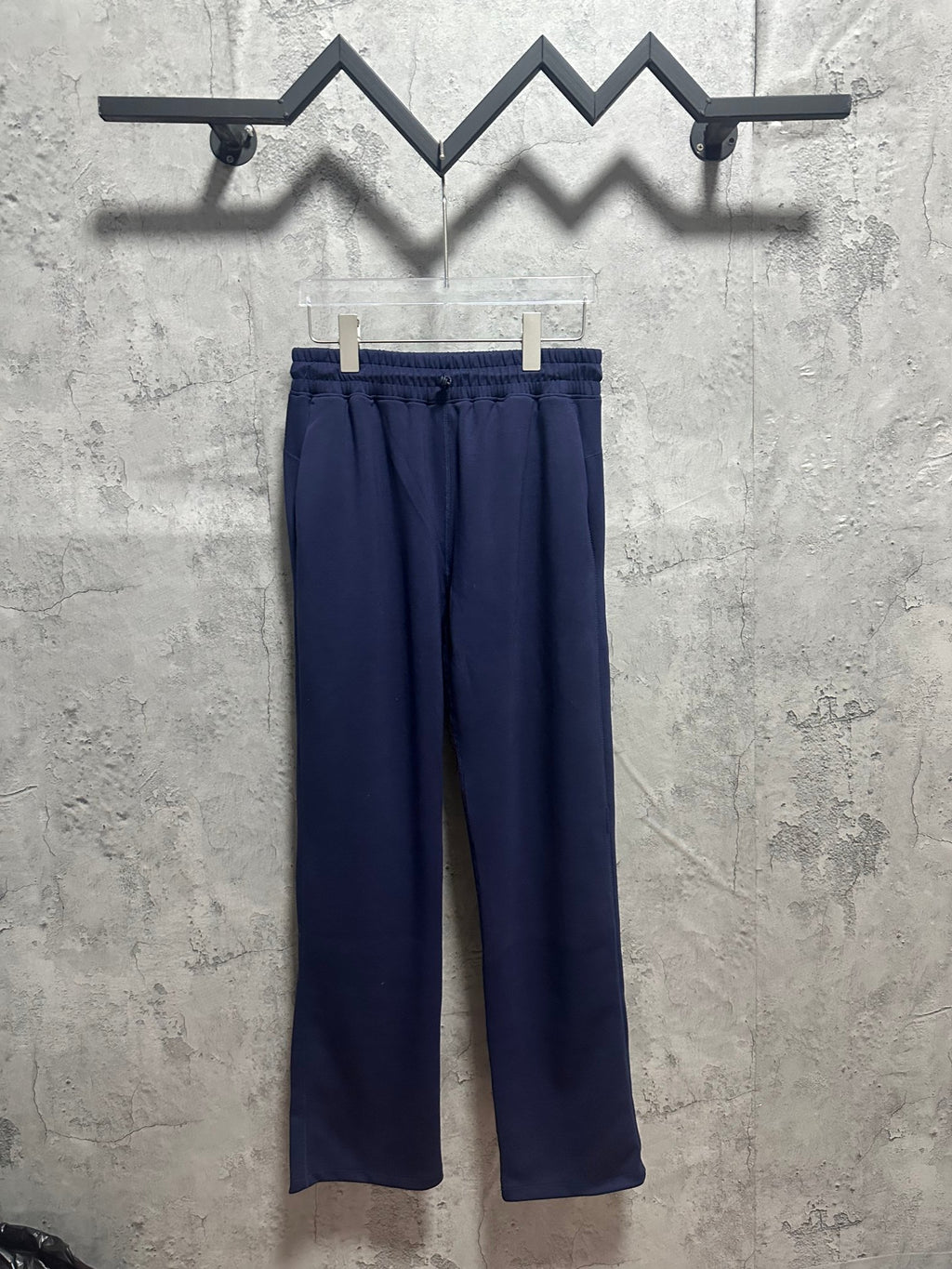 Navy relaxed-fit trousers with elastic waistband and straight, wide legs