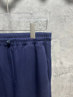 Navy elastic waistband trousers with stitched front and drawstring accents
