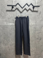 Dark blue drawstring track pants with elastic waist and relaxed straight legs