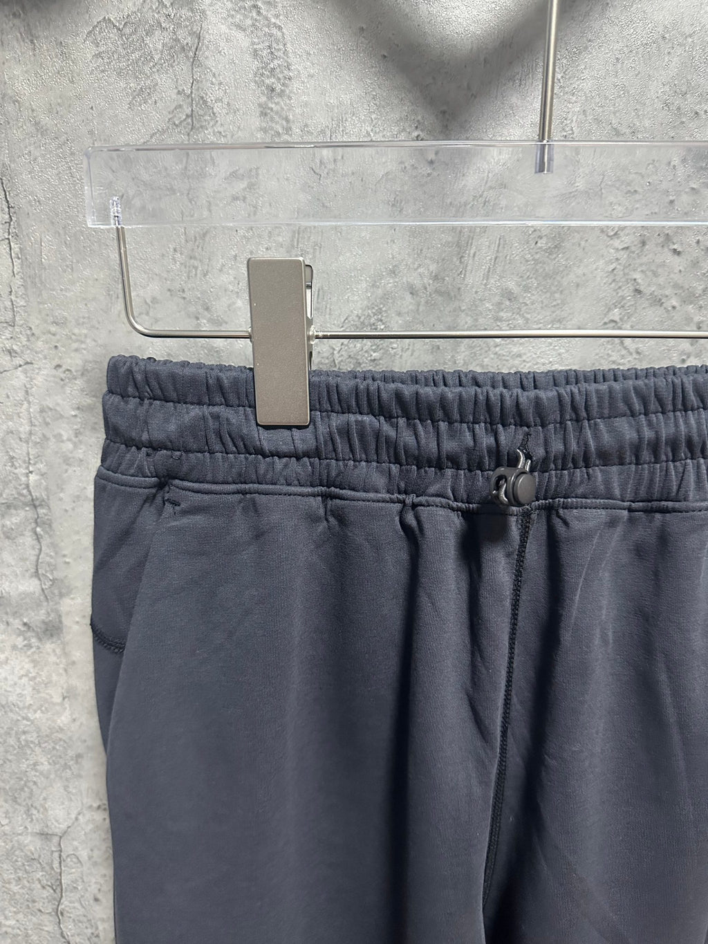 Dark blue track pants waistband with elastic and adjustable drawstring