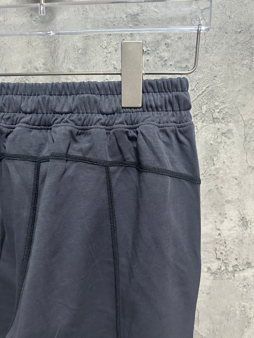 Dark blue sweatpants with elastic waistband and stitched front panel