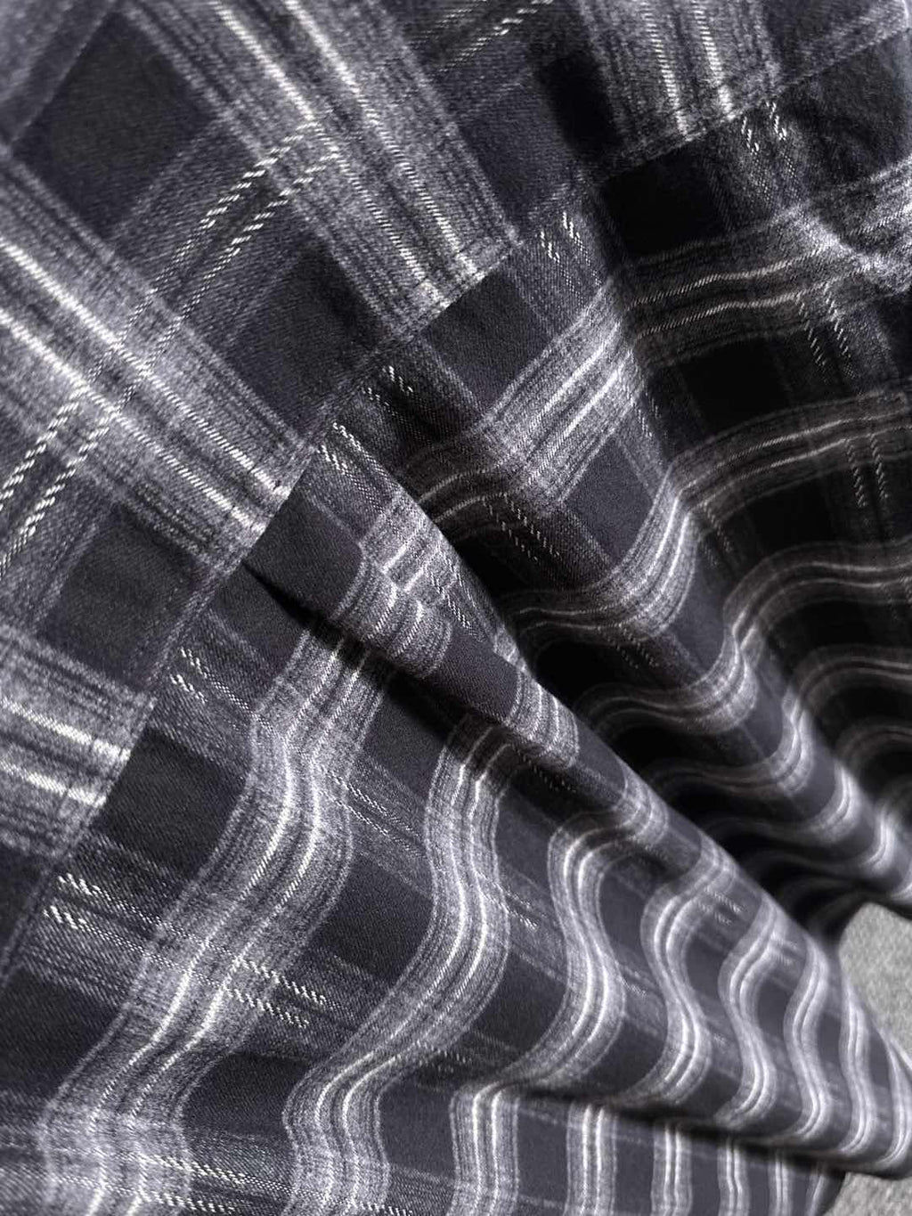 Fendi plaid fabric close-up, black-and-gray wavy check pattern