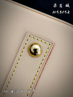 Louis Vuitton beige leather bag detail with gold stud and stitched trim
