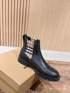 Black leather Chelsea boot with check elastic side panel and low-profile rubber sole