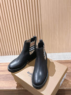 Black Chelsea boots with check-pattern elastic side and treaded sole