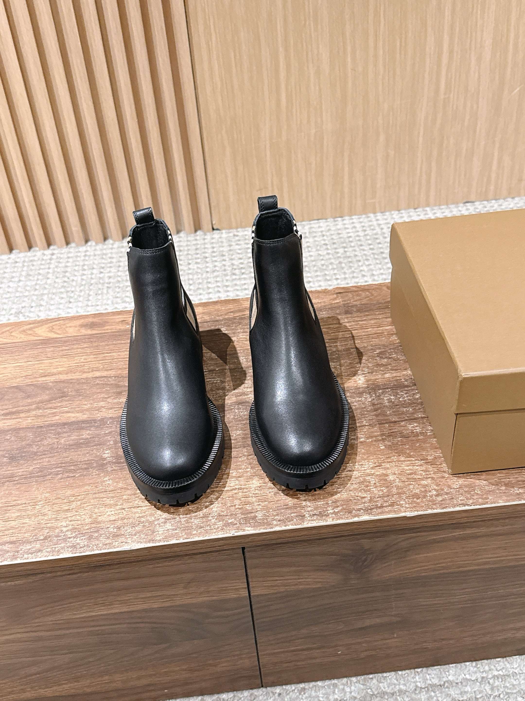 Black Chelsea boots with elastic side panels and chunky rubber sole