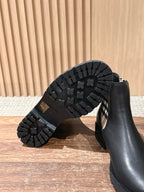 Outsole view of black Chelsea boot with deep tread and side wall detail