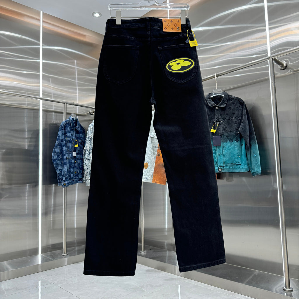 Dark denim pants with side logo patch, belt loops, and button fly