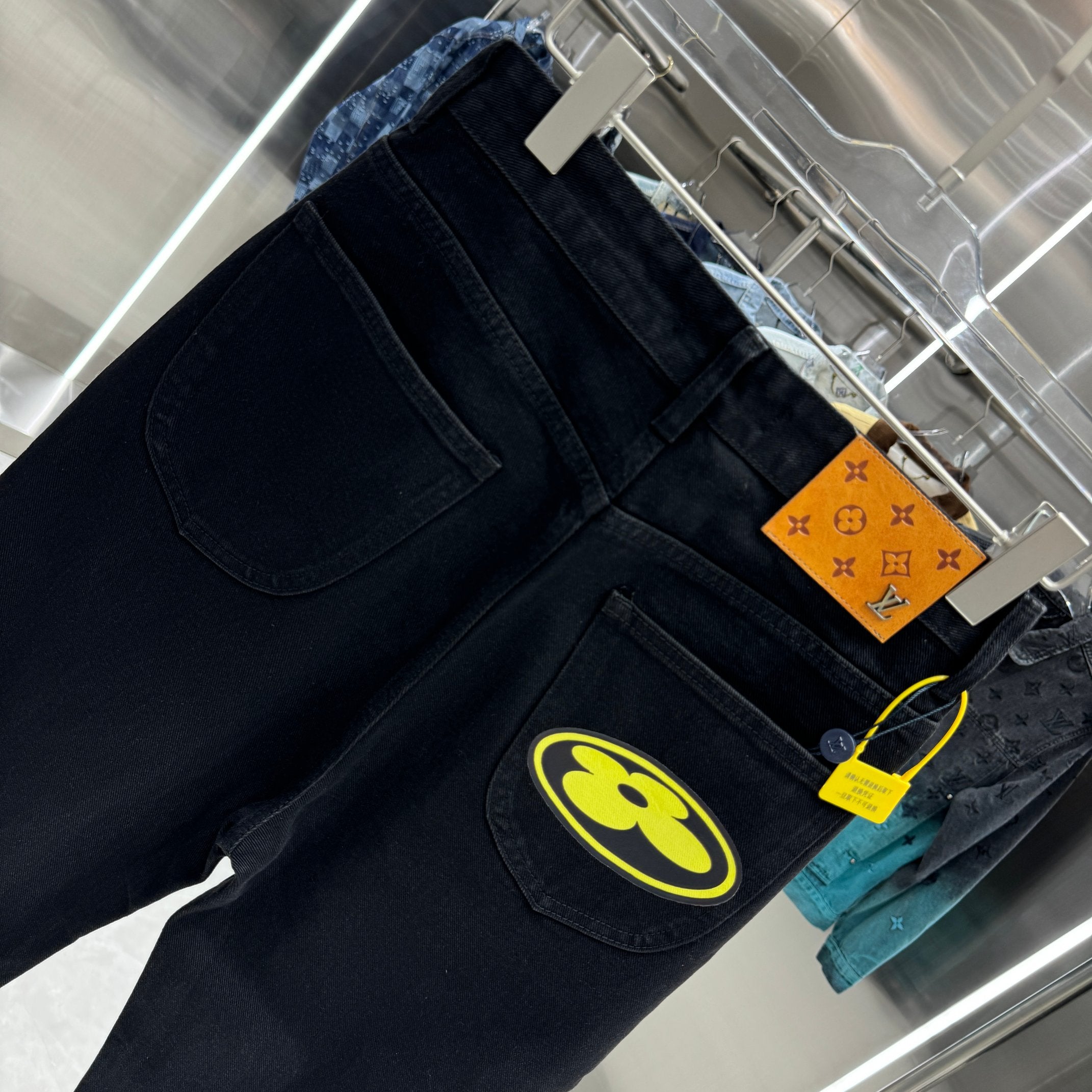 Dark denim pants with belt area label and large front logo patch