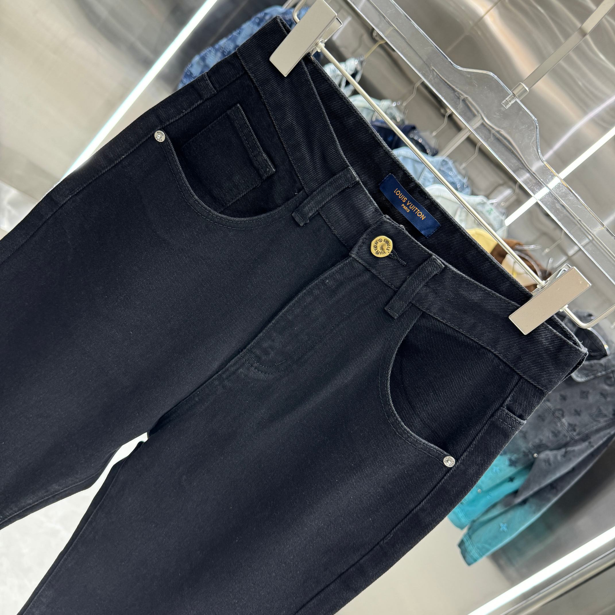 Dark blue denim jeans with front pockets and stitched waistband