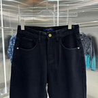 Dark blue denim jeans on hanger with front pockets and gold button